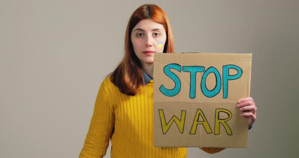 Antiwar Protest Girl with Stop War Sign and Bloody Red Hand