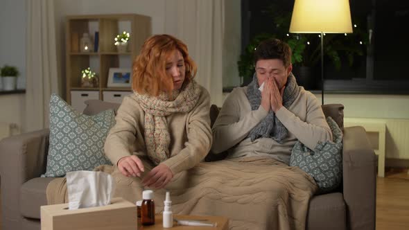 Sick Young Couple at Home in Evening