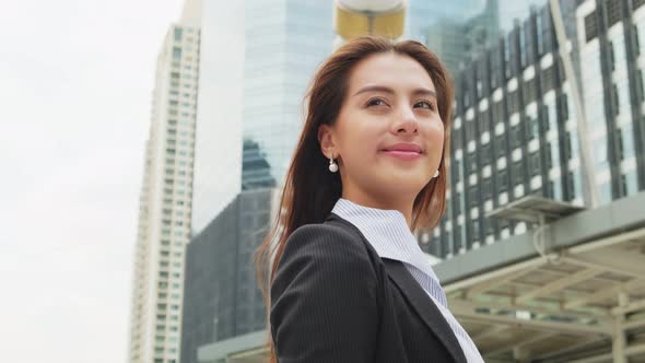 Portrait of Asian young beautiful smart business woman stand outdoor in company office in city.