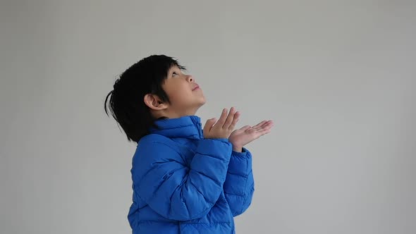 Cute Asian Child In Blue Winter Clothes Open Palm Hands Slow Motion