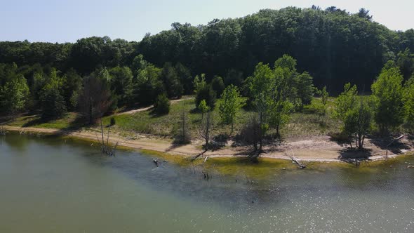 Sun cast sparkling on warm waters at a Muskegon nature reserve.