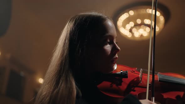 Portrait of Beautiful Young Lady with Red Violin on Scene of Old Opera House Beautiful Violinist is