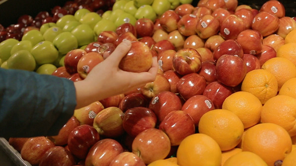 Selecting Red Apples at a Organic Grocery Store