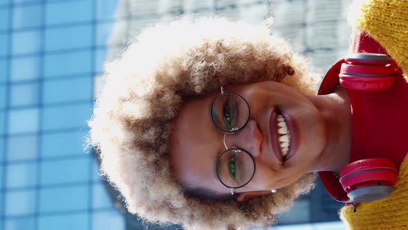 Vertical Video of American Woman with Headphones and with Afro Hair