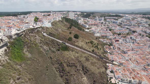 Aerial Orbit over Nazaré Railway Funicular on hillside scenic overlook of Sitío Nazaré
