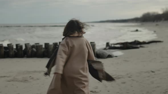 Young Woman Run And Spin Alone On The Seashore