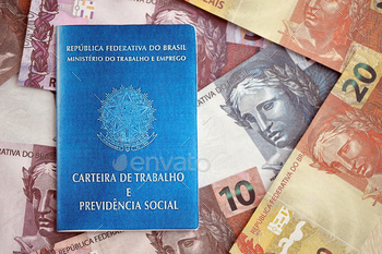 Brazilian work card and social security blue book and reais money bills