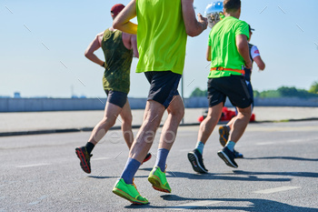 Marathon runners on city road.