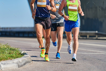 Marathon runners on city road.