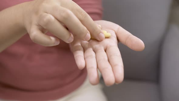 Woman taking large amount of pills. Drug addiction concept.