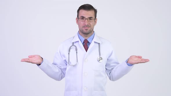 Young Hispanic Man Doctor Shrugging Shoulders