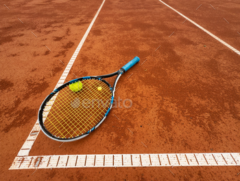 tennis racket with a tennis ball on a tennis court