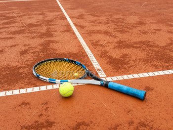 tennis racket with a tennis ball on a tennis court