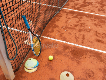 tennis racket with a tennis ball on a tennis court