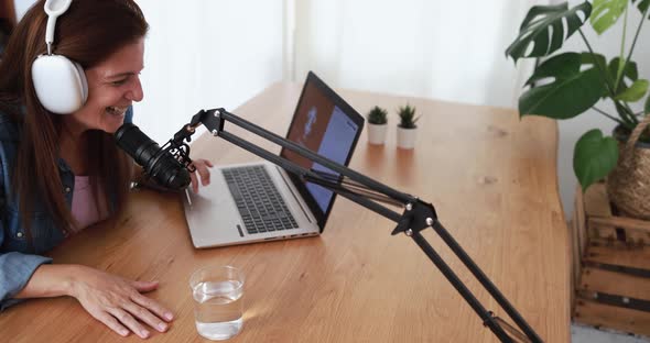 Influencer woman doing podcast using computer laptop at home - Technology trend concept