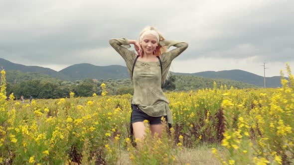 Front View of Beautiful Blond Young Girl Walks Outdoor in Nature Toward Camera Smiles and Relax