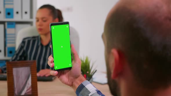 Manager in Wheelchair Using Greenscreen Smartphone