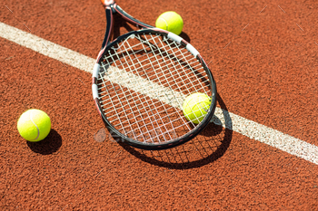 tennis racket with a tennis ball on a tennis court