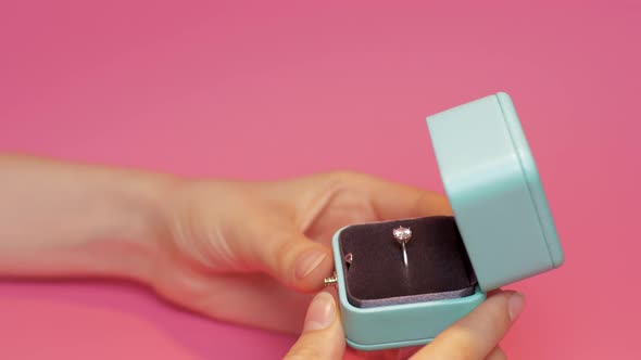 Woman Holds Ring in Wedding Box