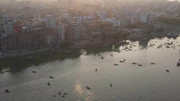 Aerial backward zoom of Ganges river banks in a dusty sunset