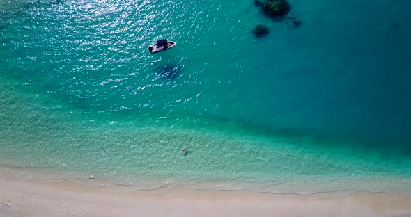 Tropical above tourism shot of a summer white paradise sand beach and blue ocean background in best 