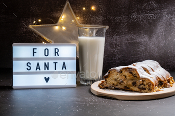 Lightbox with text FOR SANTA Christmas Stollen with glass of milk for SANTA in Christmas lights and