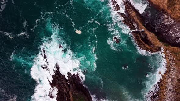 Ocean Waves Flow into Narrow Cove in Big Sur Cali, Wide Overhead Drone Shot