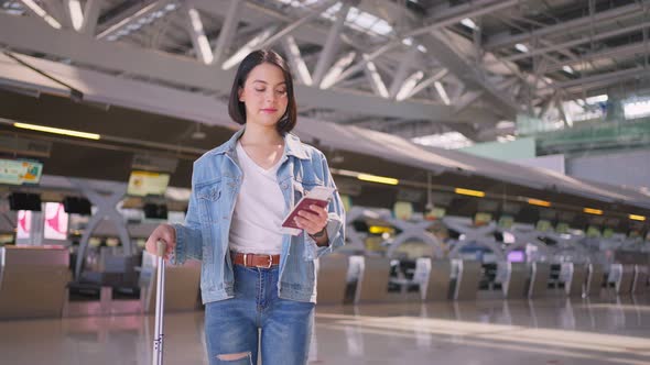 Asian beautiful woman passenger traveler walking in airport terminal to boarding gate to airplane.