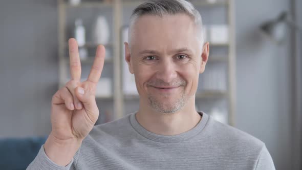 Victory Sign By Positive Gray Hair Man