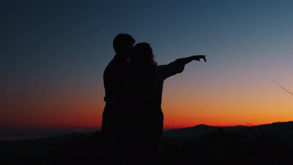 Silhouette of a Couple Boy and Girl Watching the Sky