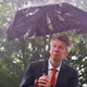 Businessman Sheltering Underneath a Broken Umbrella in the Rain - VideoHive Item for Sale