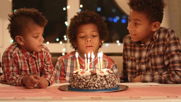 Boy Blows Out the Candles and Make a Wish.