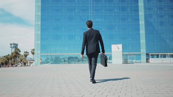 Flexible and cool businessman doing acrobatic tricks outdoor.