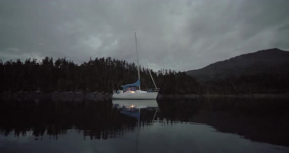 Anchored Sailboat by Scenic Alaskan Coastline in Twilight During White Nights