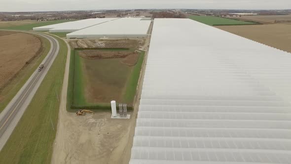 Aerial image flying over farm greenhouses.