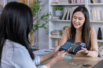 QR code payment, customer using smartphone for paying at shop.