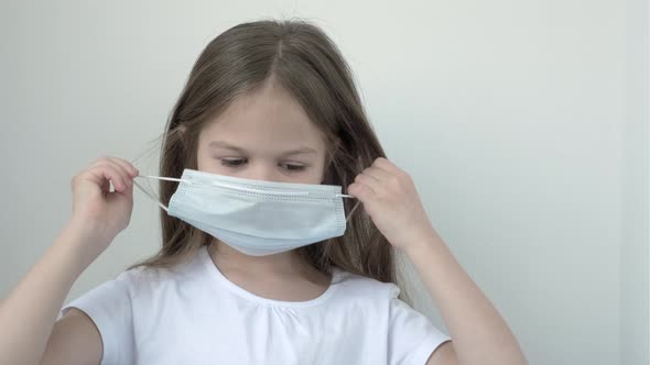 Little Girl Taking Off Protective Face Mask and Breathing Pure Fresh Air