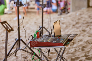 Mixing console, stage sound mixer at beach party, sound engineering audio mixing console desk