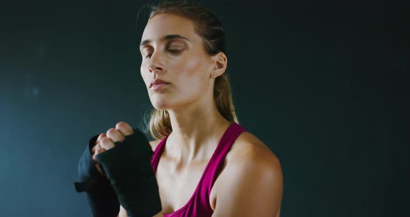 Athletic Woman Training Kickboxing in the Gym