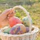 Close-up of children hand holding a basket with Easter eggs in sunshine - VideoHive Item for Sale