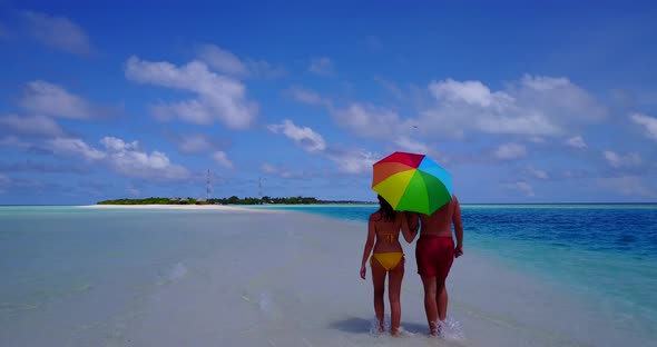 Fun people after marriage in love spend quality time on beach on white sand background 