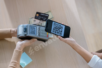 QR code payment, customer using smartphone for paying at shop.