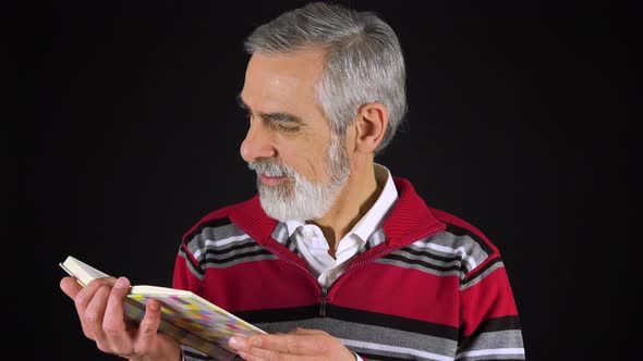 An Elderly Man Reads a Book - Black Screen Studio