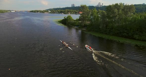 Sports Canoe Driven By Team Men Women Sailing Along Calm River with Sun