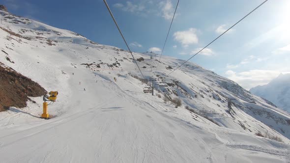 Ski Lifts and Snow Covered Mountains on a Sunny Day.