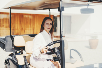 Woman in a golf cart driving