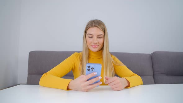 Cheerful white female browsing social media app news feed in modern mobile phone gadget in 4k video