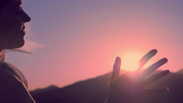 Female Hands Playing with Sun Beams