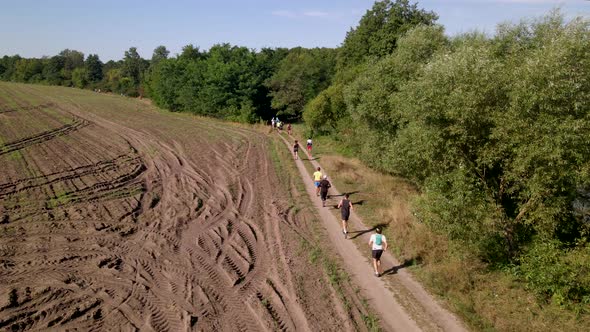 Aerial Shot of People in Trail Running Marathon in a Countryside Field Road, Slow Motion  60 Fps