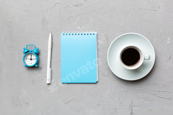 Modern office desk table with notebook and other supplies with cup of coffee. Blank notebook